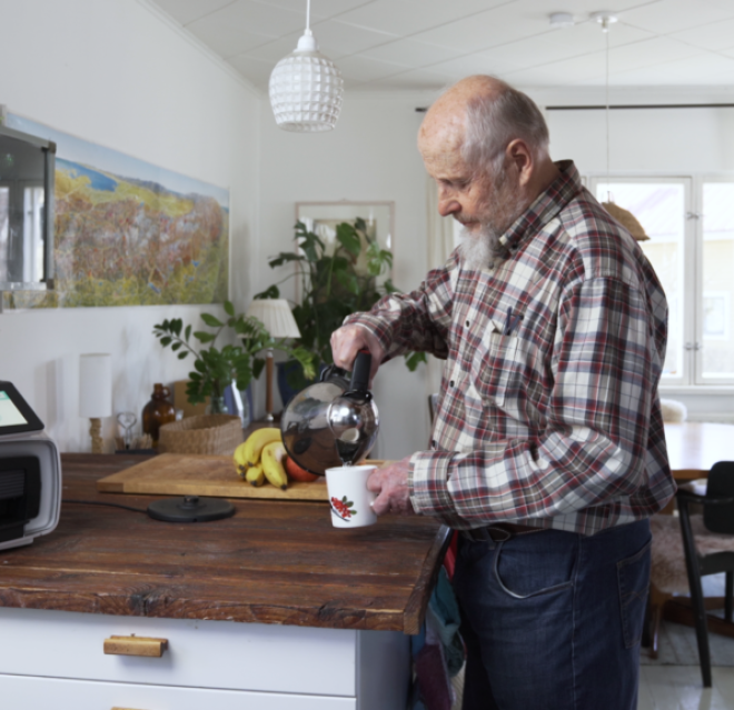 Seniori kotona kahvikuppi kädessä