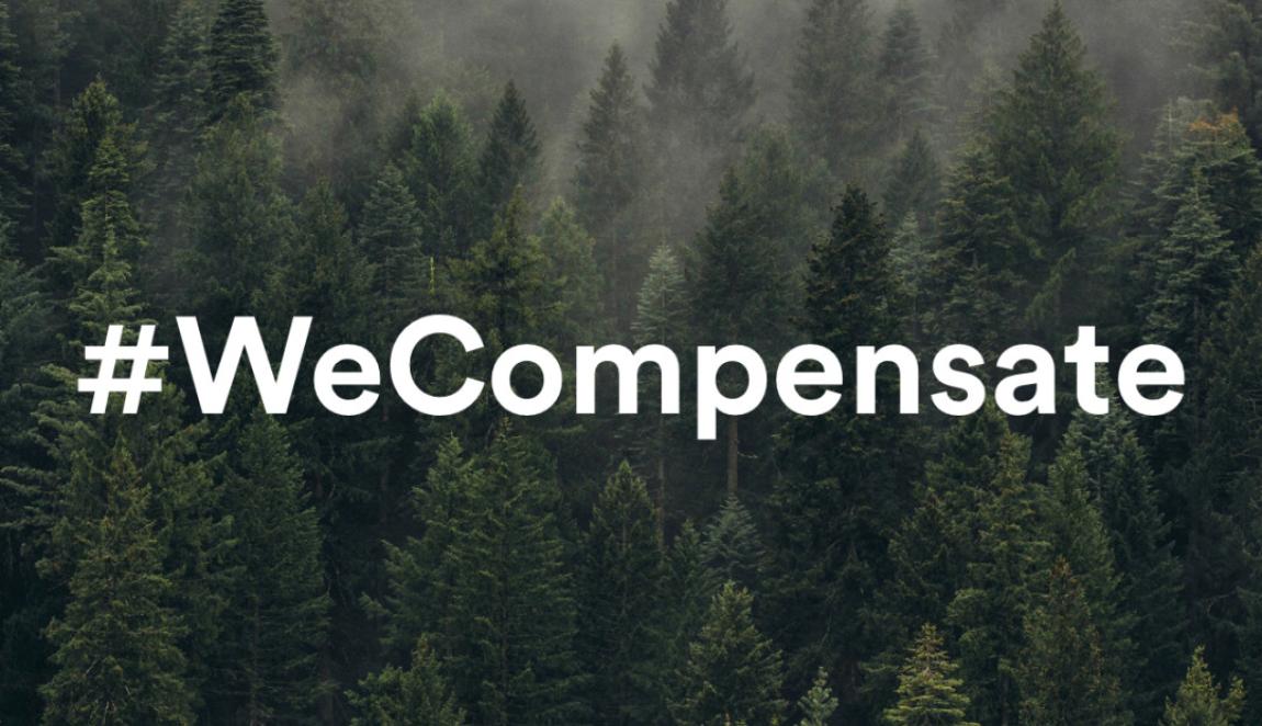 Kuva kuusimetsästä, jonka päällä teksti #WeCompensate.